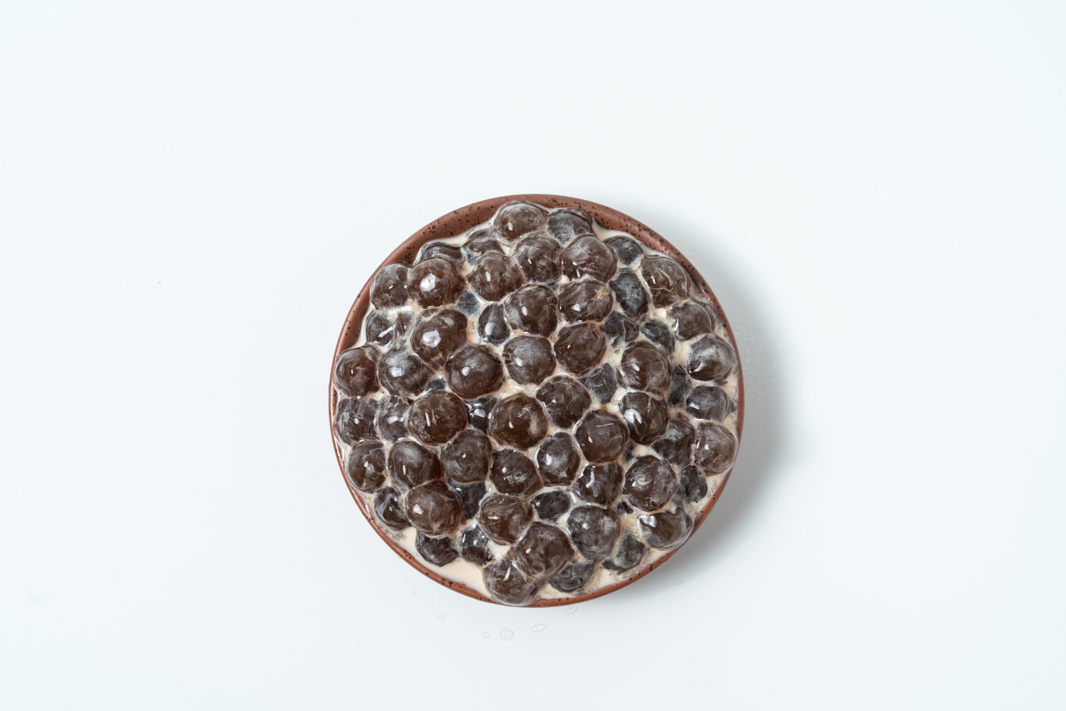 A Glass Cup of Pearl Milk Tea (Also Called Bubble Tea) and a Plate of Tapioca Ball on White Background. Pearl Milk Tea Is the Most Representative Drink in Taiwan. Taiwan Food . with Copy Space.